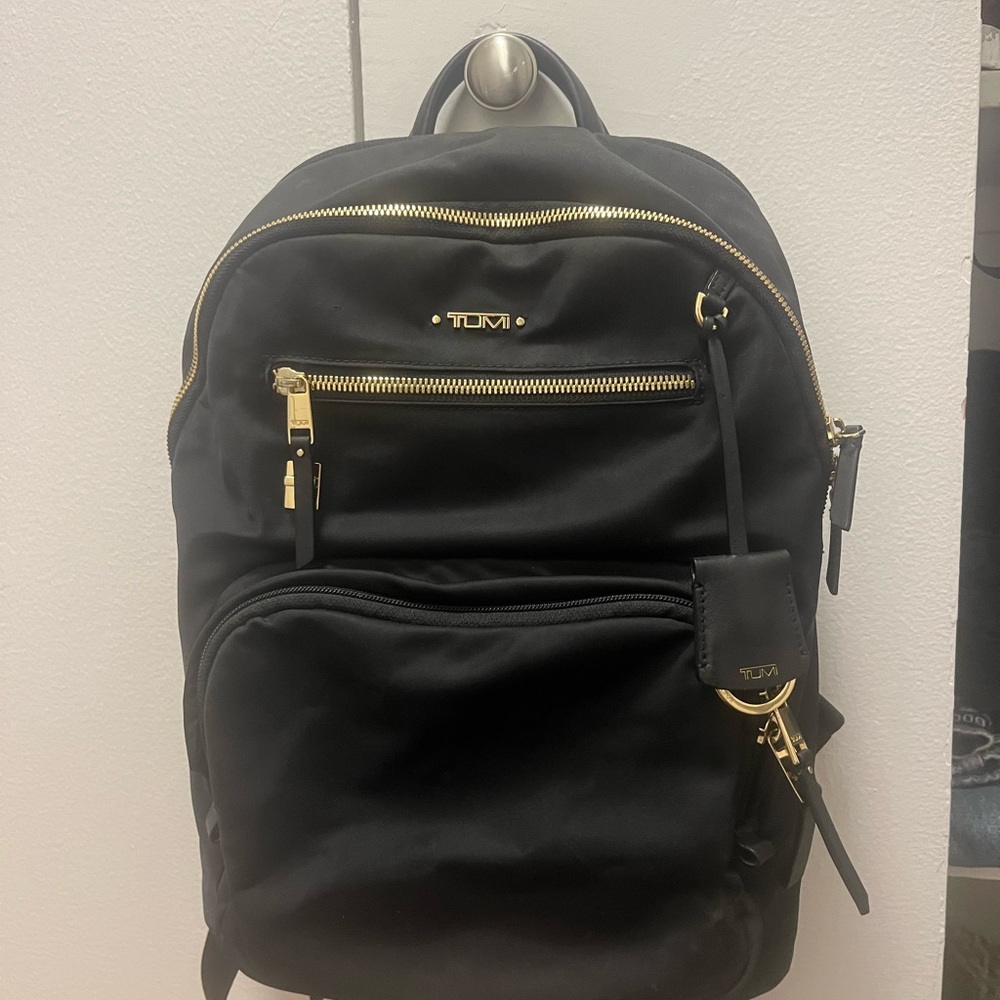 Tumi Black and Gold Backpack Sleek Design